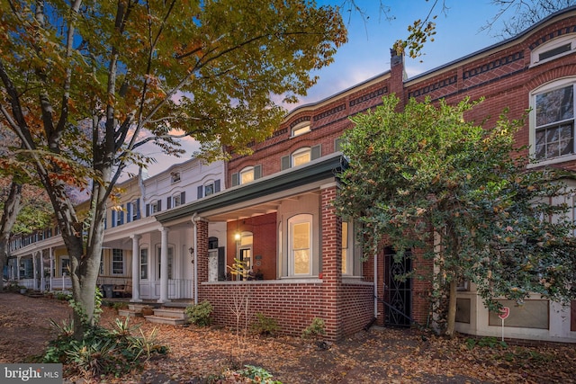 townhome / multi-family property featuring a porch