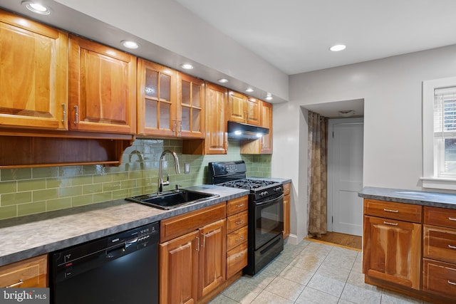 kitchen featuring light tile patterned floors, black appliances, sink, and backsplash