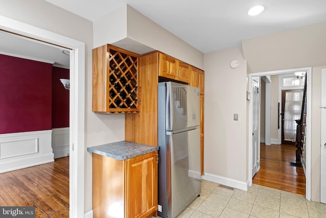 kitchen featuring light hardwood / wood-style floors and stainless steel refrigerator