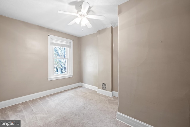 carpeted empty room featuring ceiling fan