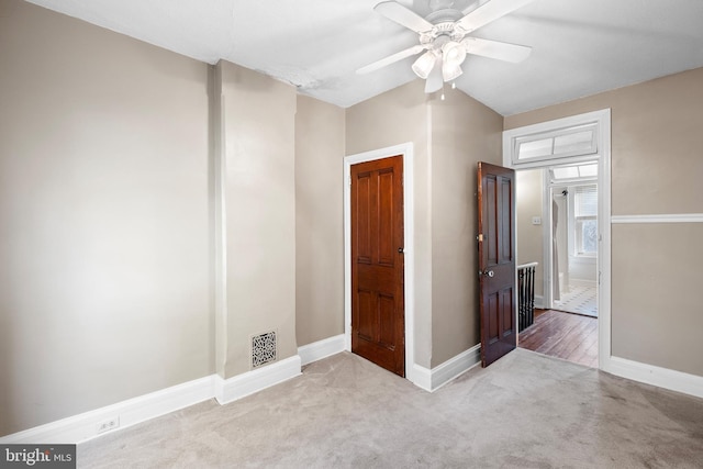 carpeted empty room featuring ceiling fan