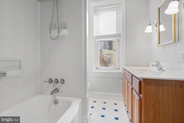 full bathroom with vanity, tiled shower / bath combo, and toilet