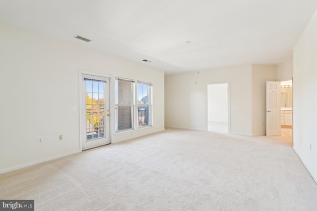 unfurnished room with light carpet