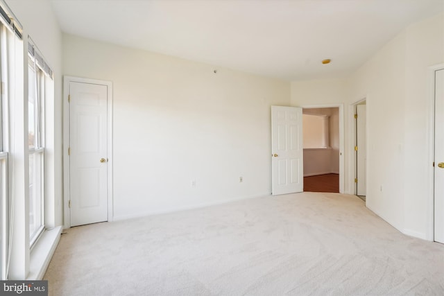 unfurnished bedroom with light colored carpet