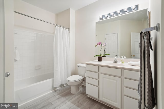 full bathroom with vanity, toilet, hardwood / wood-style flooring, and shower / bath combo with shower curtain