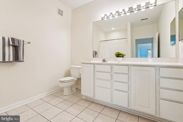 bathroom featuring vanity, a shower with shower curtain, toilet, and tile patterned flooring