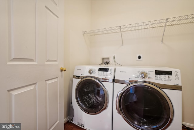 laundry area featuring dark hardwood / wood-style floors and washing machine and clothes dryer