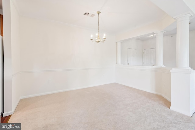 empty room featuring an inviting chandelier, carpet flooring, and ornate columns