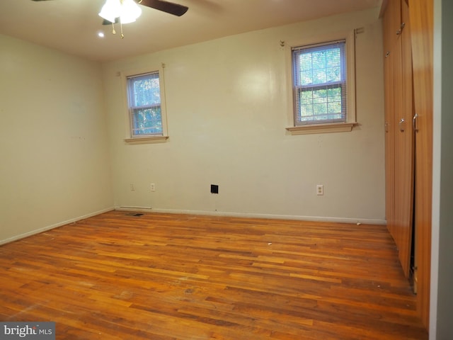 empty room featuring ceiling fan and hardwood / wood-style flooring