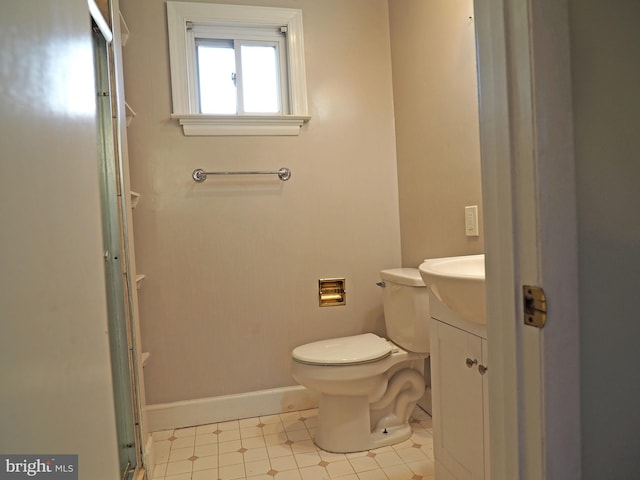 bathroom with vanity, an enclosed shower, and toilet