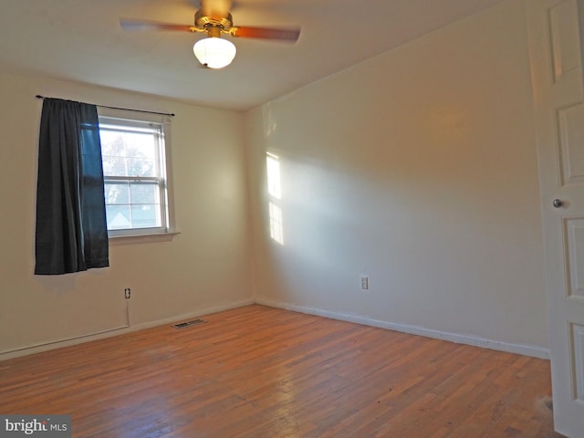 spare room featuring hardwood / wood-style flooring and ceiling fan