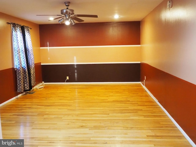 spare room with light hardwood / wood-style floors and ceiling fan