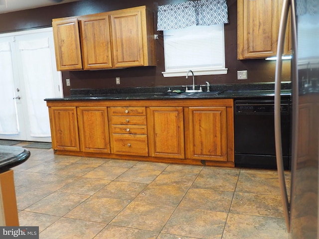 kitchen with dishwasher, dark stone countertops, and sink