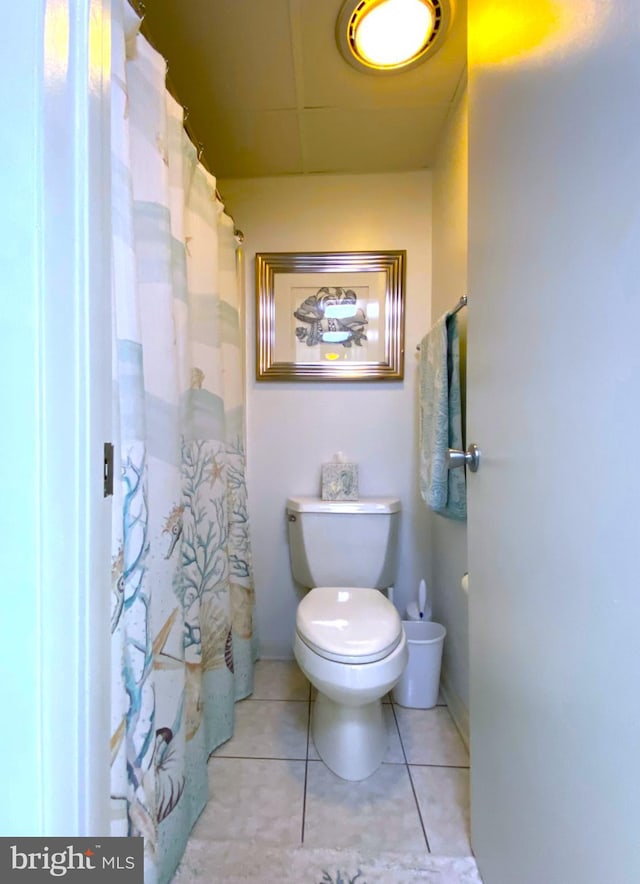 bathroom with toilet and tile patterned floors