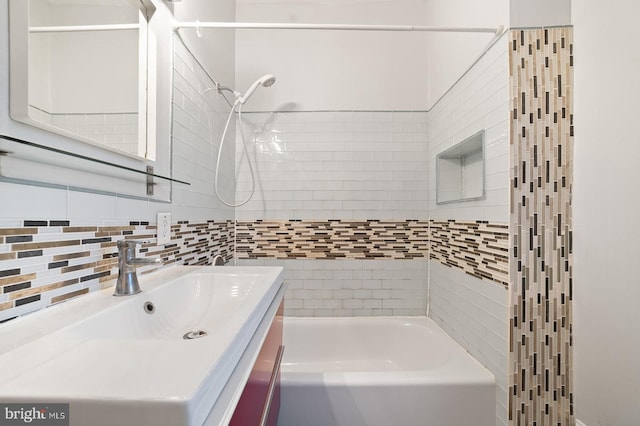 bathroom featuring vanity and tiled shower / bath combo