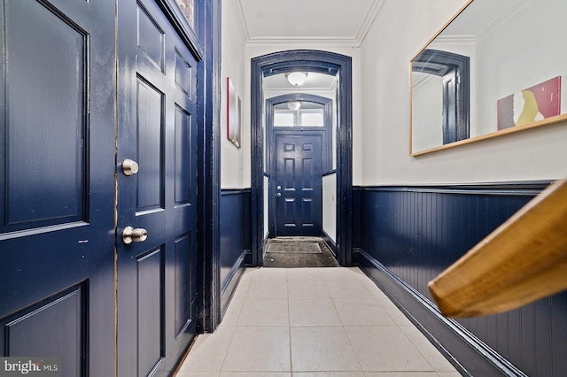 doorway to outside featuring crown molding and tile patterned flooring