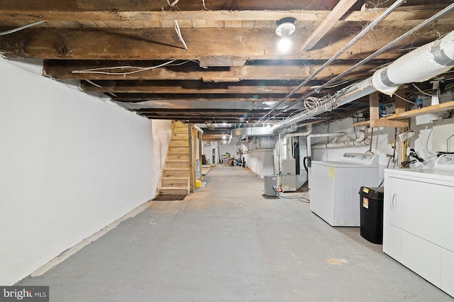 basement with heating unit and separate washer and dryer