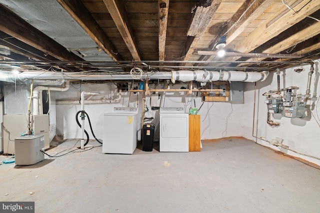 basement with heating unit and washing machine and clothes dryer