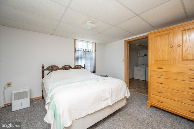 carpeted bedroom featuring washer and dryer and a paneled ceiling