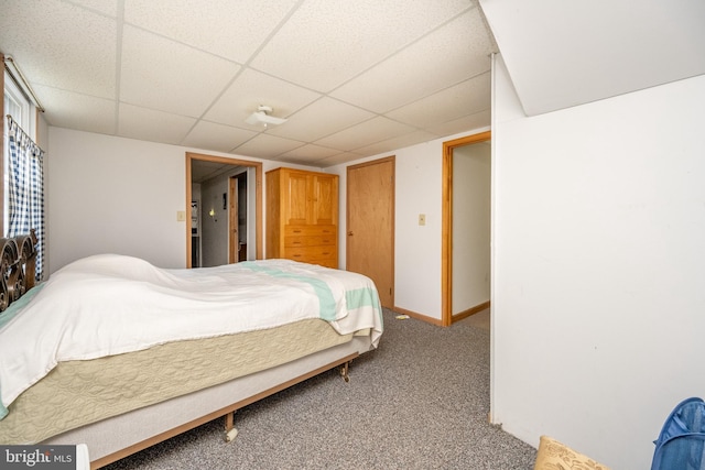 carpeted bedroom with a drop ceiling