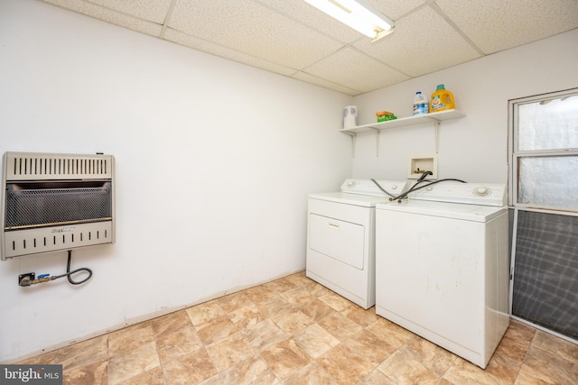 clothes washing area with washer and dryer and heating unit