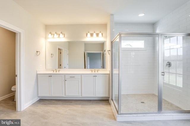 bathroom with vanity, toilet, and walk in shower