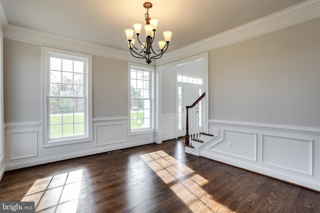 interior space with ornamental molding, a chandelier, and dark hardwood / wood-style flooring