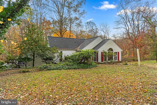 view of side of property with a yard