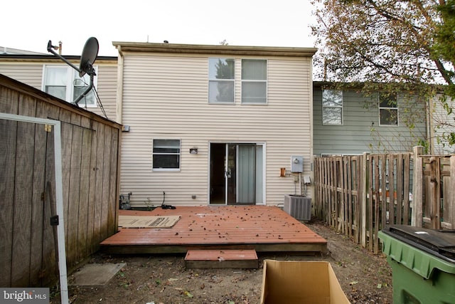 rear view of house featuring a wooden deck and cooling unit