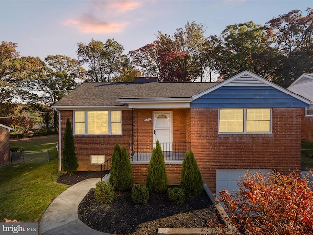 view of front of house with a yard and a garage