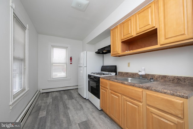 kitchen with baseboard heating, range hood, white appliances, and sink