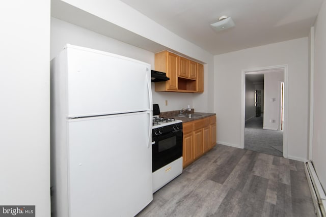 kitchen with white appliances, dark wood-type flooring, a baseboard heating unit, and sink