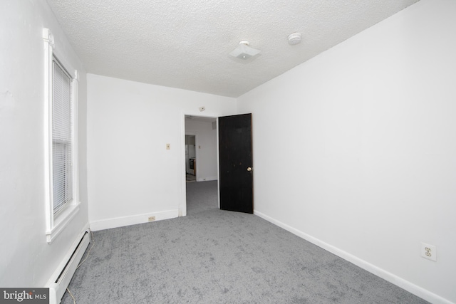 empty room with light carpet, a textured ceiling, and a baseboard radiator