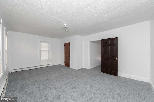 empty room featuring a textured ceiling, carpet flooring, and baseboard heating