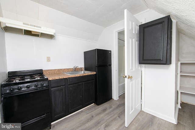 kitchen with lofted ceiling, black appliances, sink, light wood-type flooring, and range hood