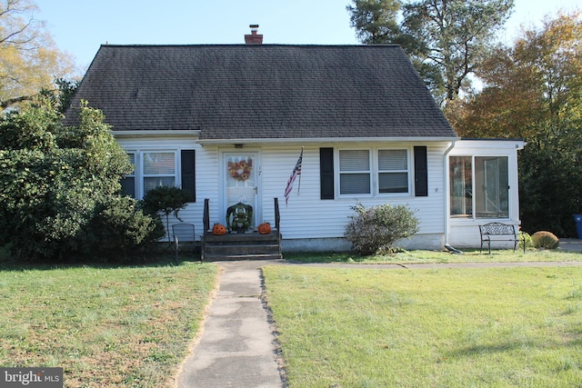 cape cod-style house with a front lawn