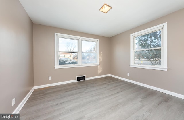 empty room with light hardwood / wood-style floors