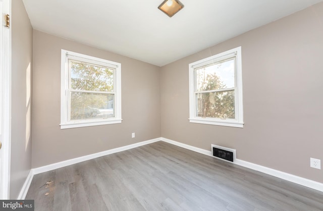 unfurnished room with light hardwood / wood-style floors