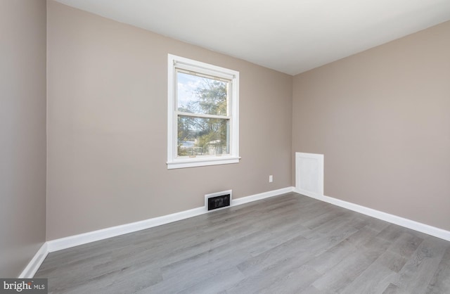 spare room featuring light hardwood / wood-style flooring