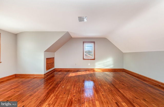 bonus room featuring lofted ceiling and hardwood / wood-style flooring