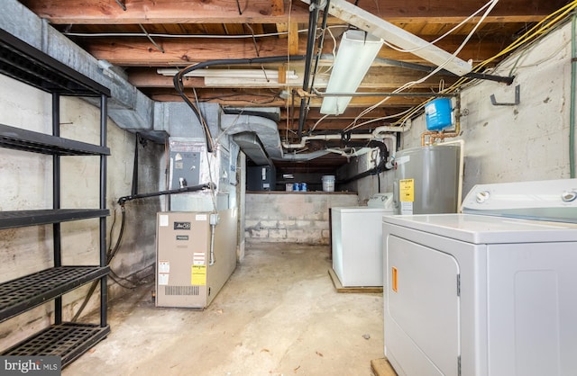 basement with heating unit, water heater, and independent washer and dryer