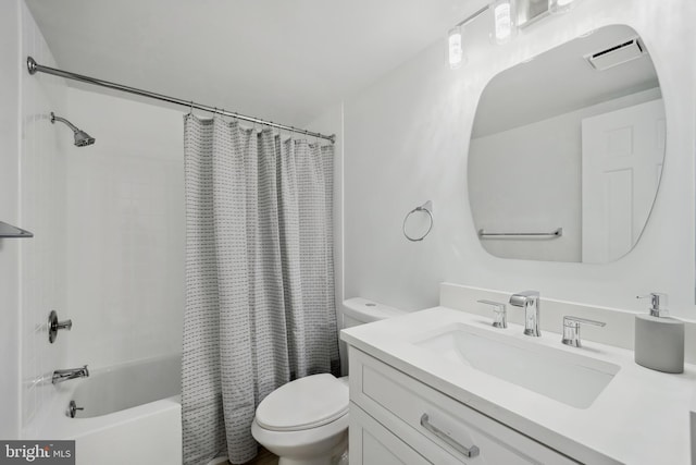 bathroom featuring visible vents, shower / bath combo with shower curtain, toilet, and vanity