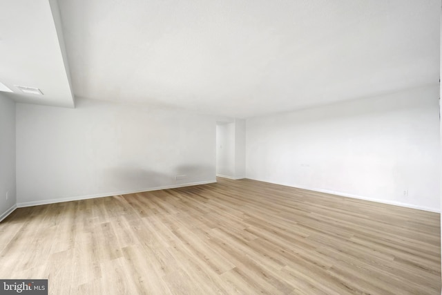 unfurnished living room featuring baseboards, light wood-type flooring, and visible vents