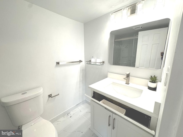 full bath featuring vanity, toilet, marble finish floor, baseboards, and a shower