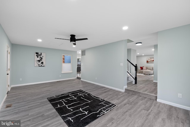 interior space with wood-type flooring and ceiling fan