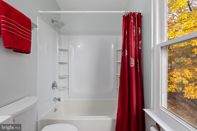 bathroom featuring toilet and shower / bathtub combination with curtain