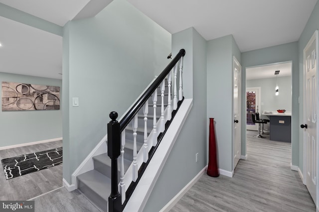 stairway with hardwood / wood-style flooring