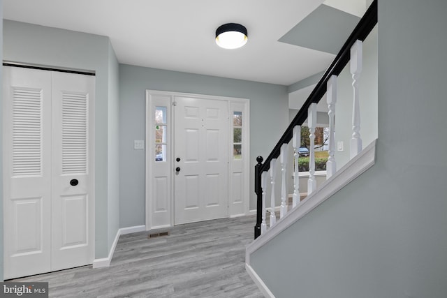 foyer entrance with light wood-type flooring