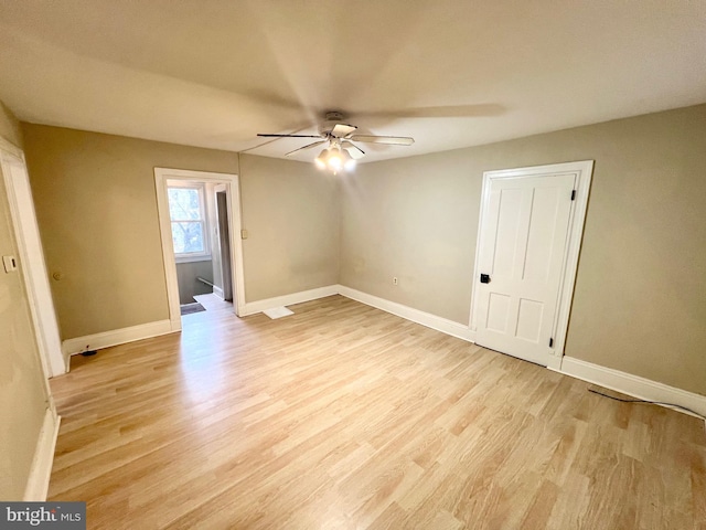 empty room featuring ceiling fan and light hardwood / wood-style flooring