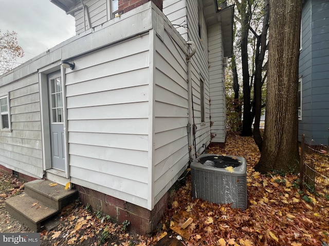 view of side of home with central air condition unit